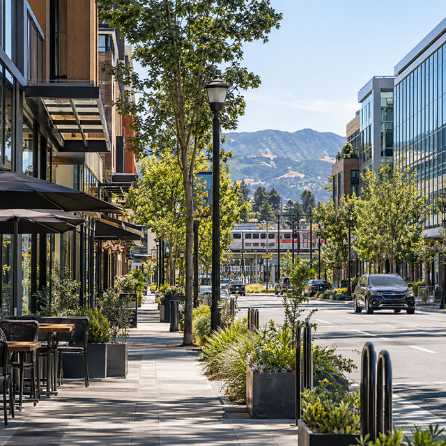 Downtown Mountain View street with shops and hills in the distance